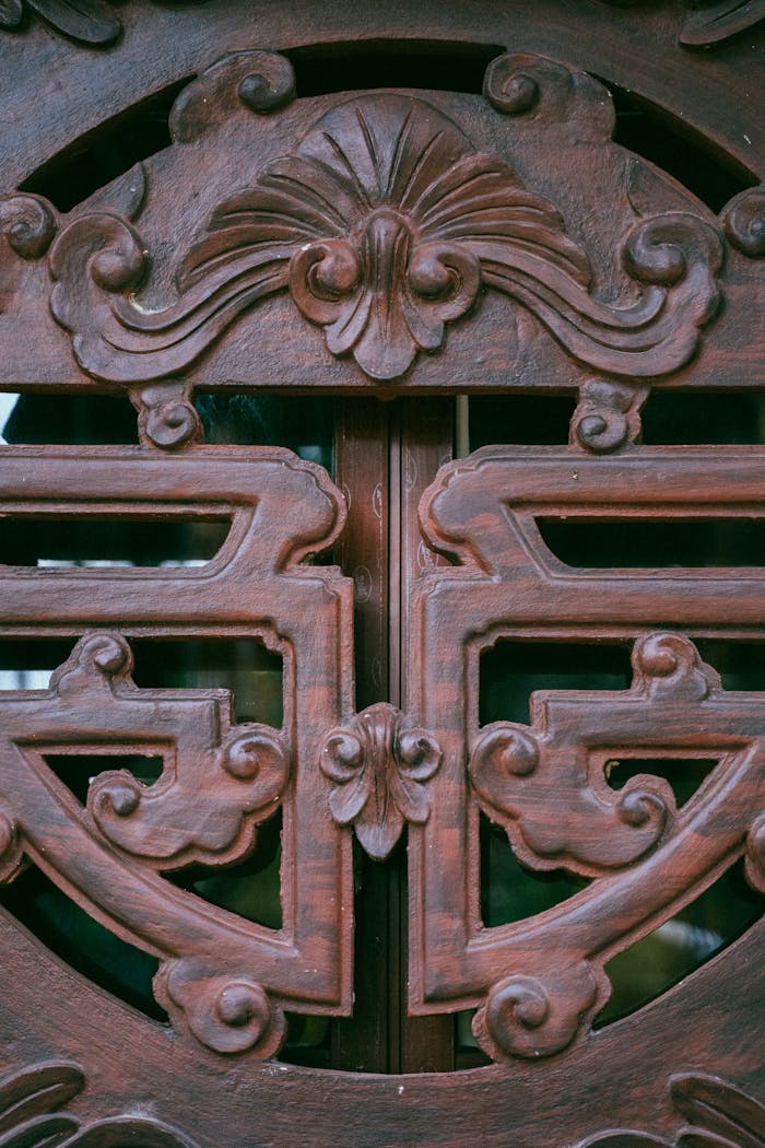 Services Close-up of intricate wooden carving on a traditional door, showcasing elegant craftsmanship.